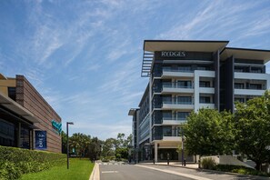 A modern building with a sign reading "RYDGES" and a cafe with a sign reading "CAFE."