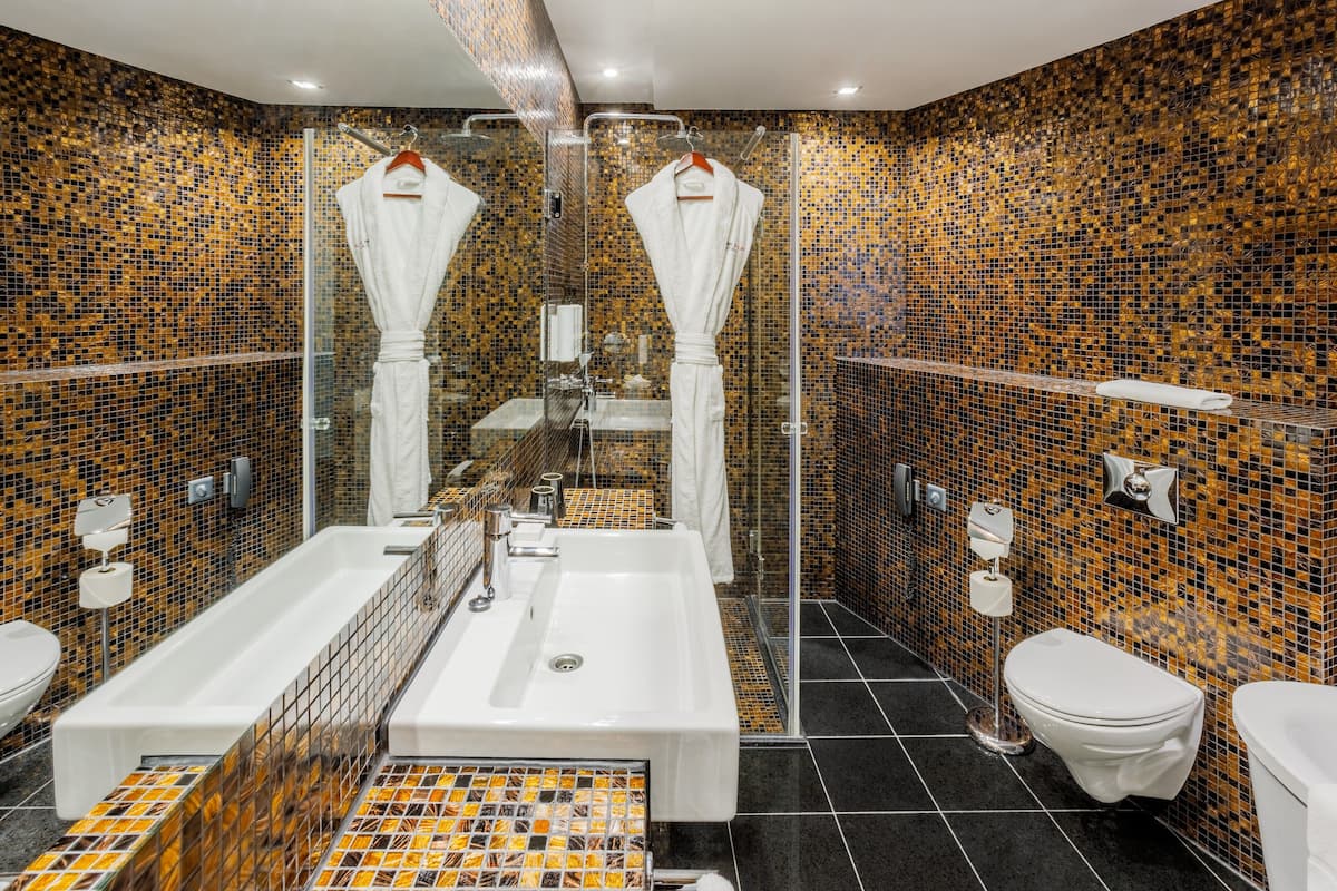 designer toiletries, hair dryer, bathrobes, slippers