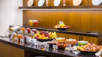 A buffet with various food items and condiments.