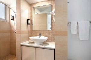 Deluxe Queen Studio | Bathroom | Shower, hair dryer, towels, soap