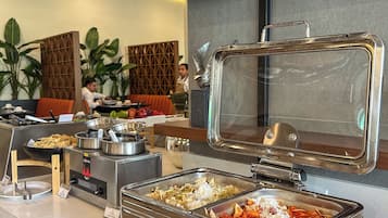 A buffet area with various food stations, including a sign for 'Garden Chilaquiles'.