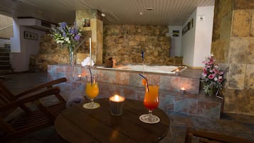 Relax in a serene space with a stone wall backdrop, a wooden staircase, and a cozy table setting.