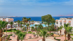 A resort with a pool area, palm trees, and a view of the sea. - Dreams Beach Sharm el Sheikh (Sharm El Sheikh)