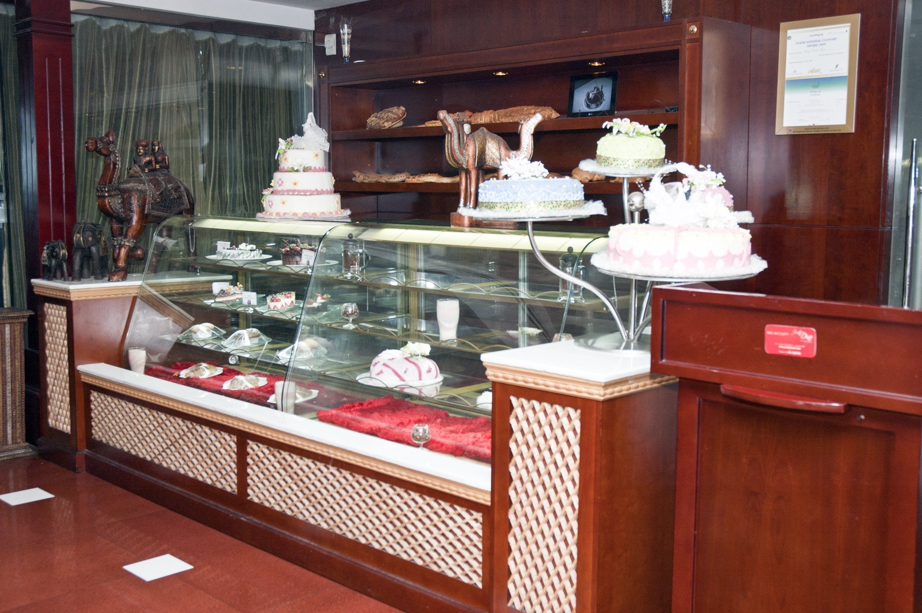 A bakery display case with various cakes and pastries.