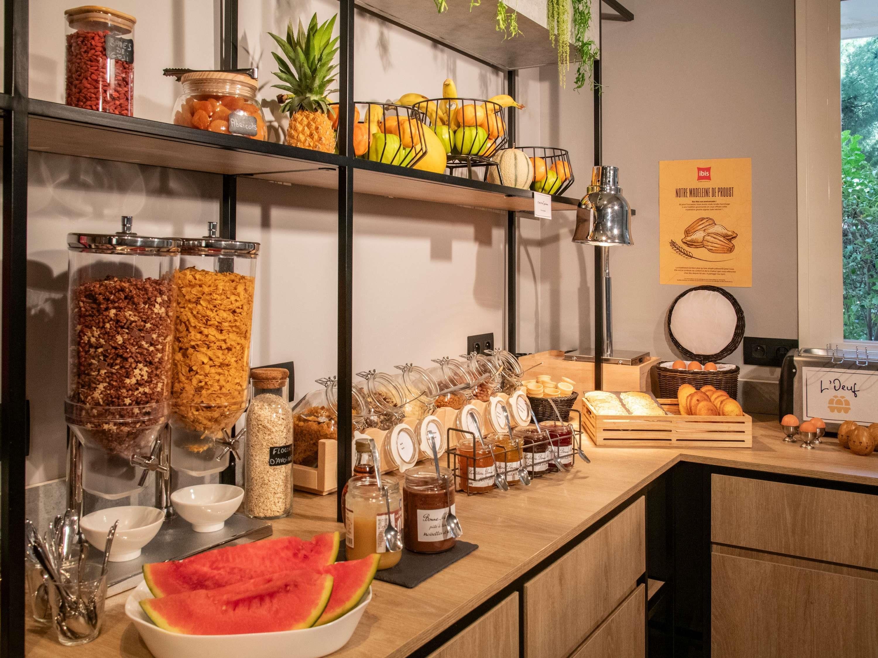 A breakfast buffet with various food items and condiments.