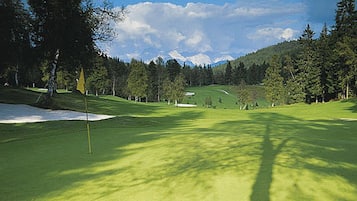 Play a round amidst lush greenery and majestic mountain views.