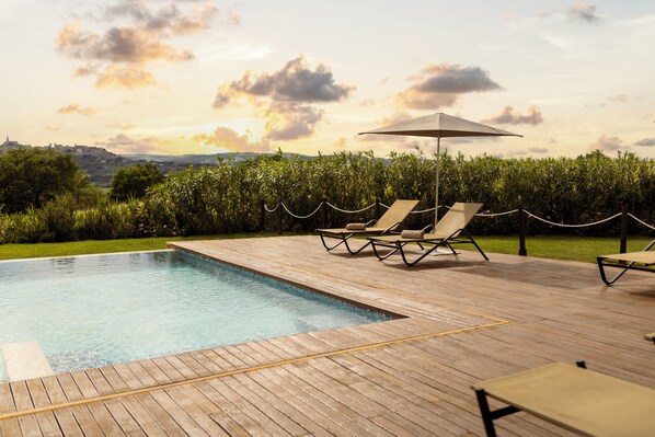 Indoor pool, outdoor pool, open 10 AM to 8 PM, pool loungers