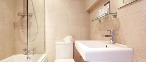 A modern bathroom with a bathtub, toilet, and sink.