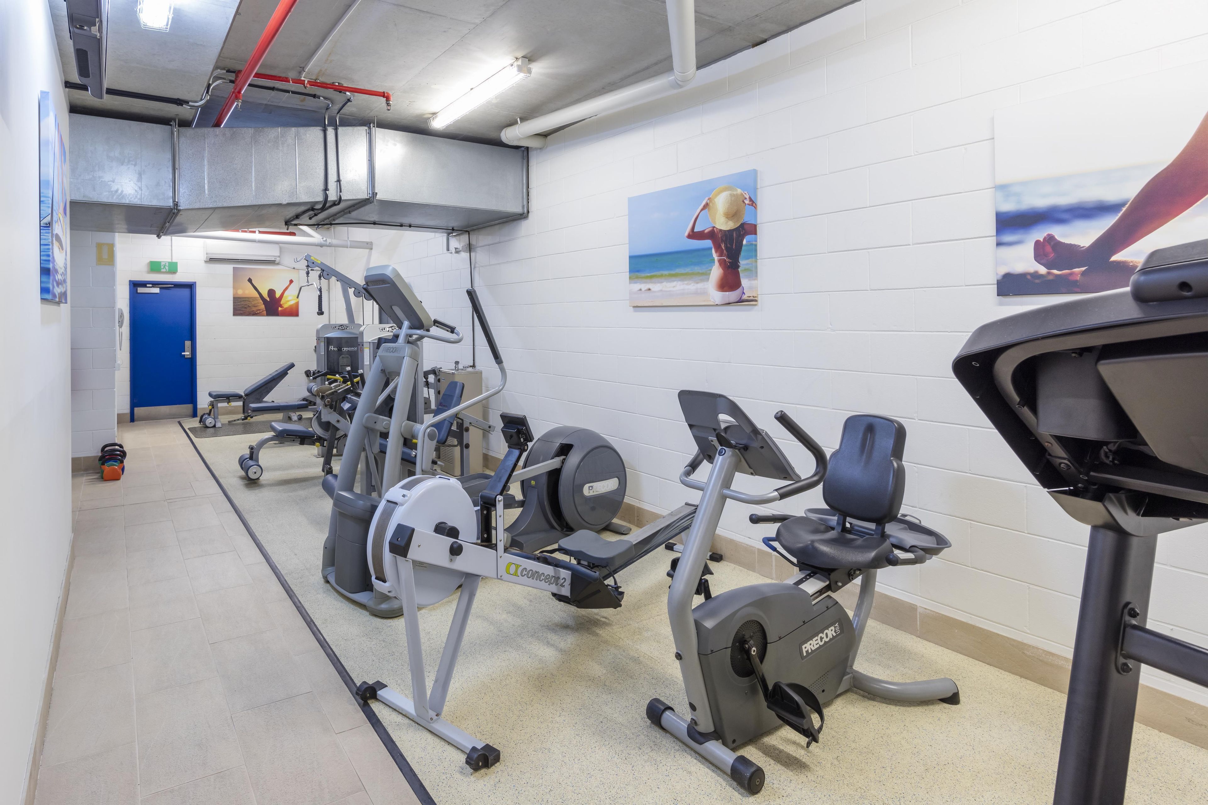 A gym with various exercise equipment, including treadmills and weight machines.