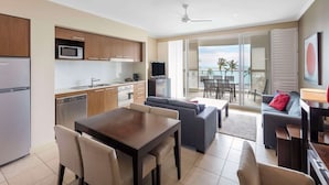 Una cocina moderna con comedor, sofá y balcón con vistas.