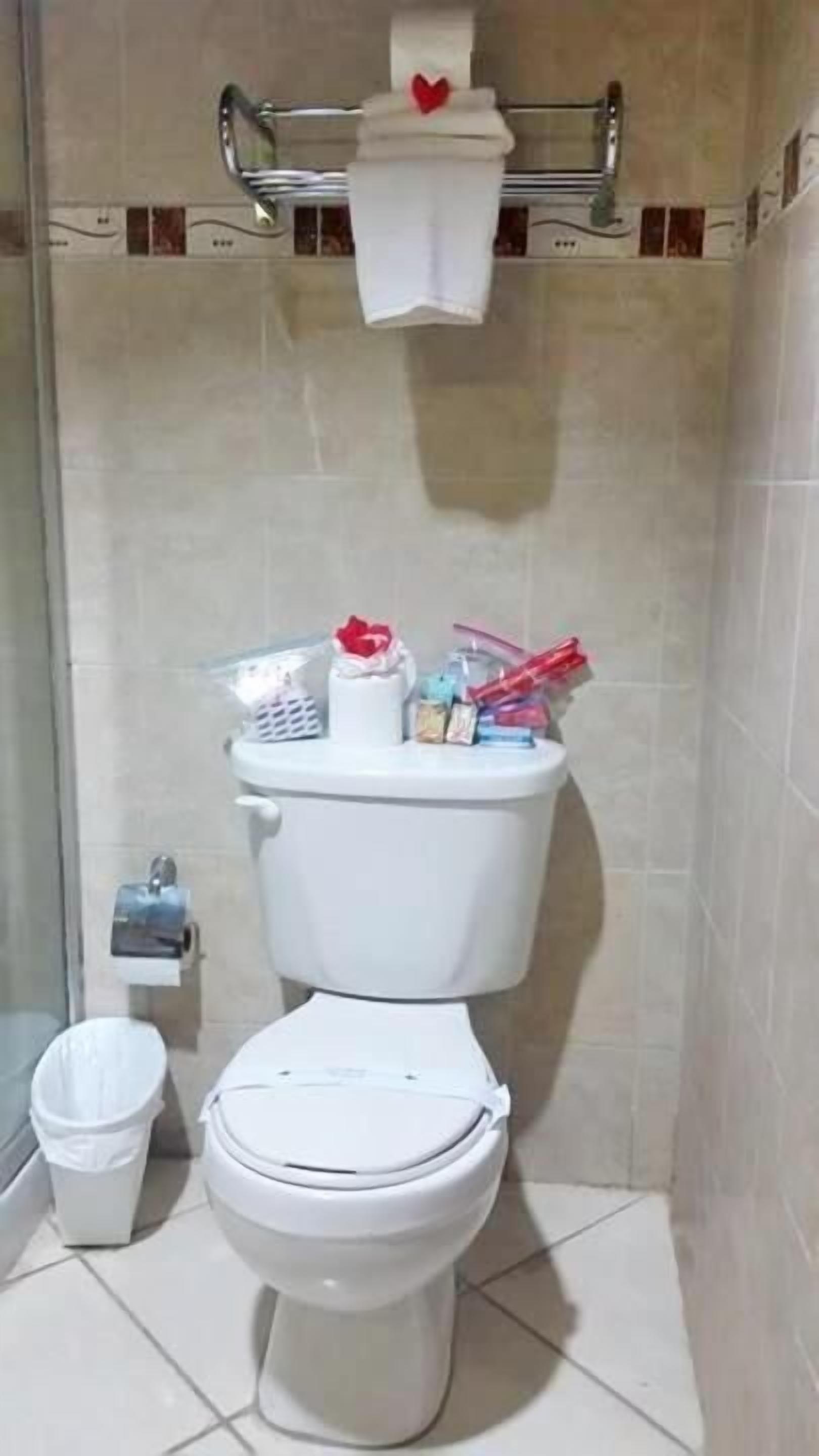 A bathroom with a toilet, a bidet, and a trash bin.