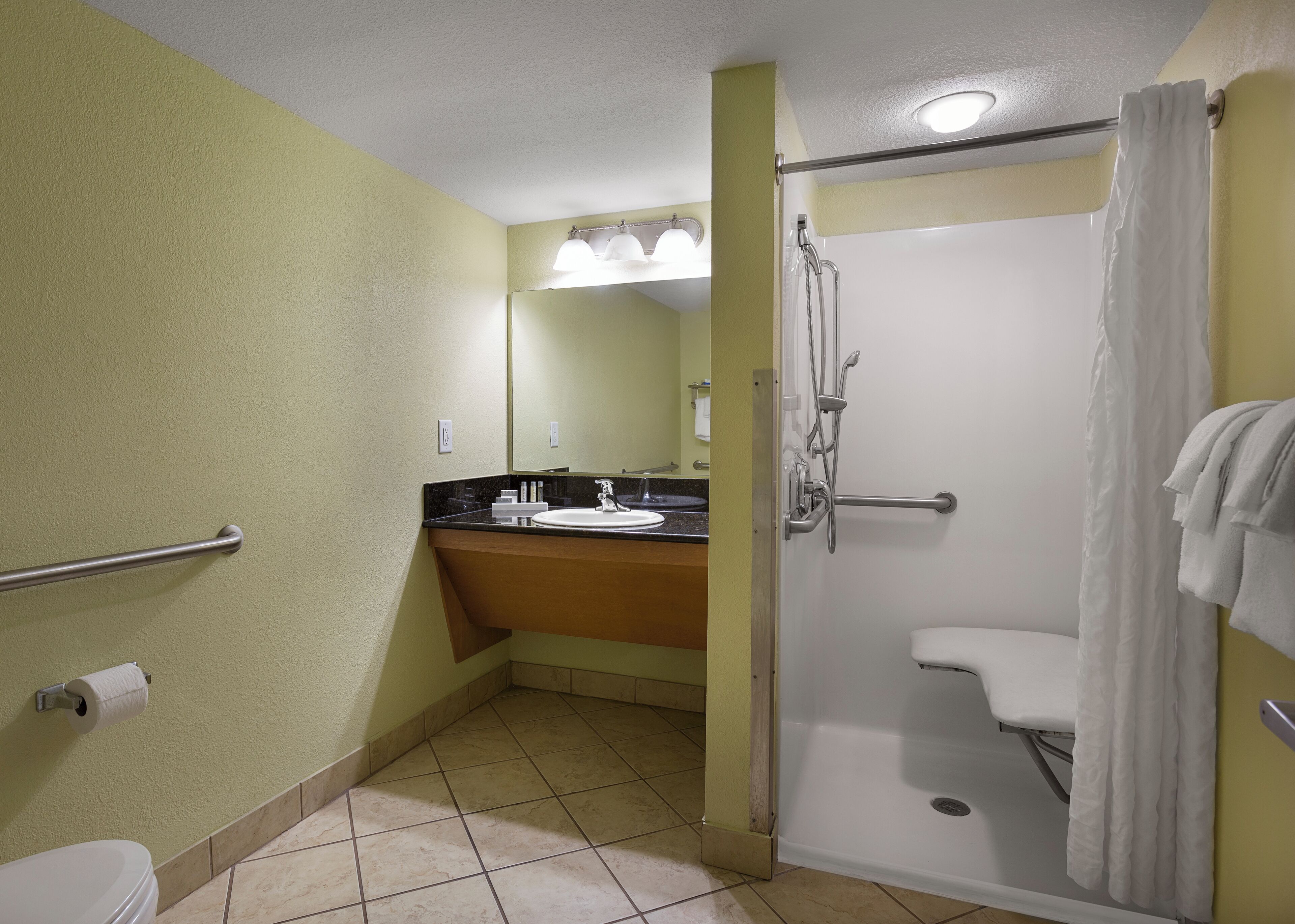 A bathroom with a toilet, sink, and shower.