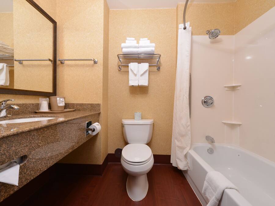 A bathroom with a sink, toilet, and bathtub.