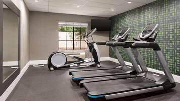 A gym with treadmills, an elliptical, and a stationary bike.