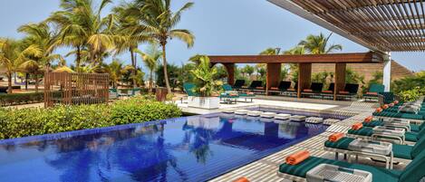 Una piscina al aire libre, sombrillas, tumbonas