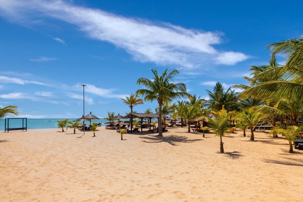 On the beach, white sand, beach umbrellas, beach towels