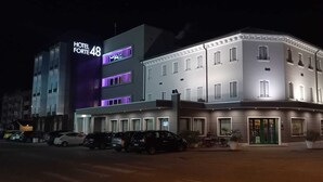 Hotellin julkisivu on moderni, siinä on suuri, selkeästi näkyvä kyltti, jossa lukee ”HOTEL FORTE 48”, ja hotellilla on useita autopaikkoja.