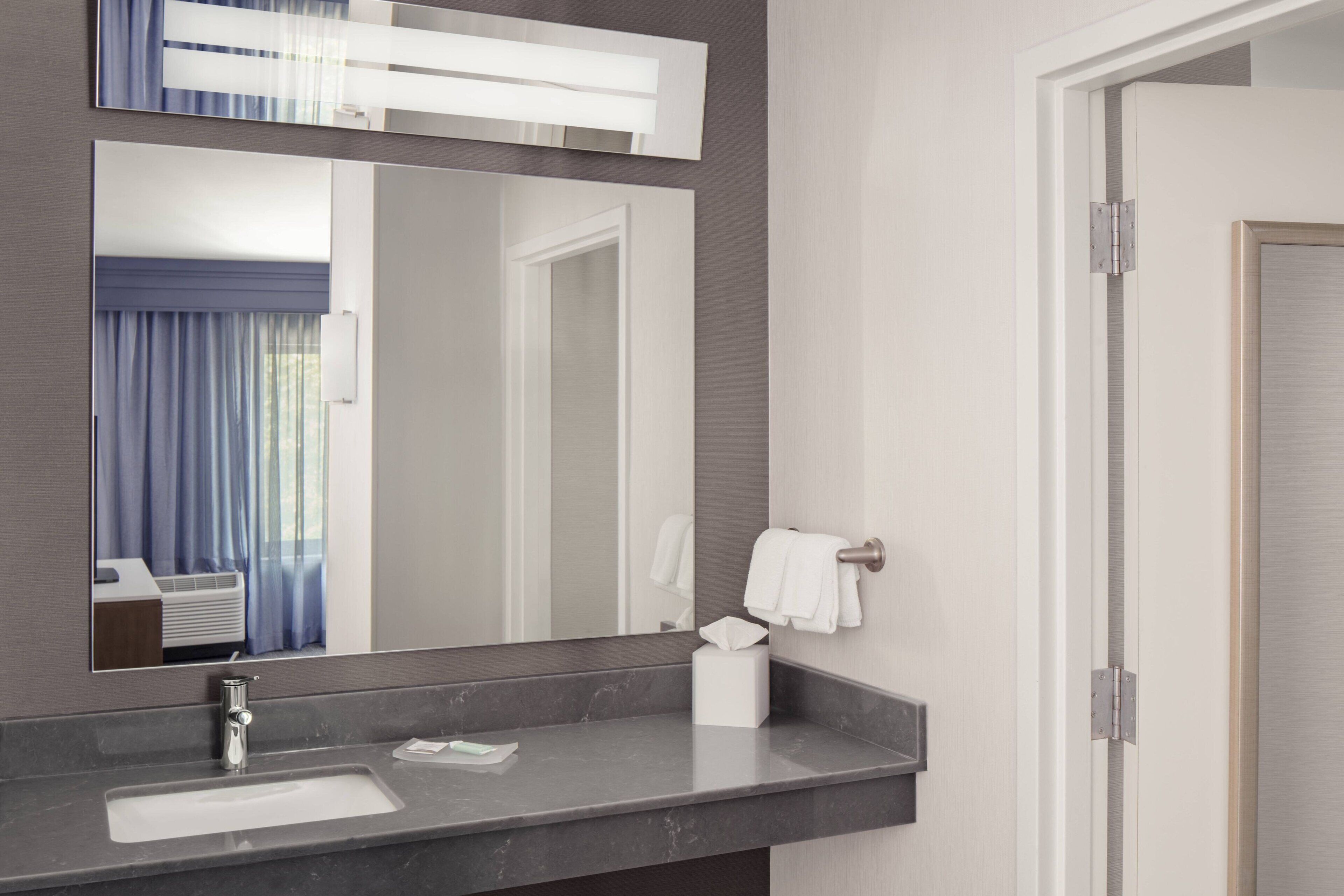 combined shower/bathtub, designer toiletries, hair dryer, towels