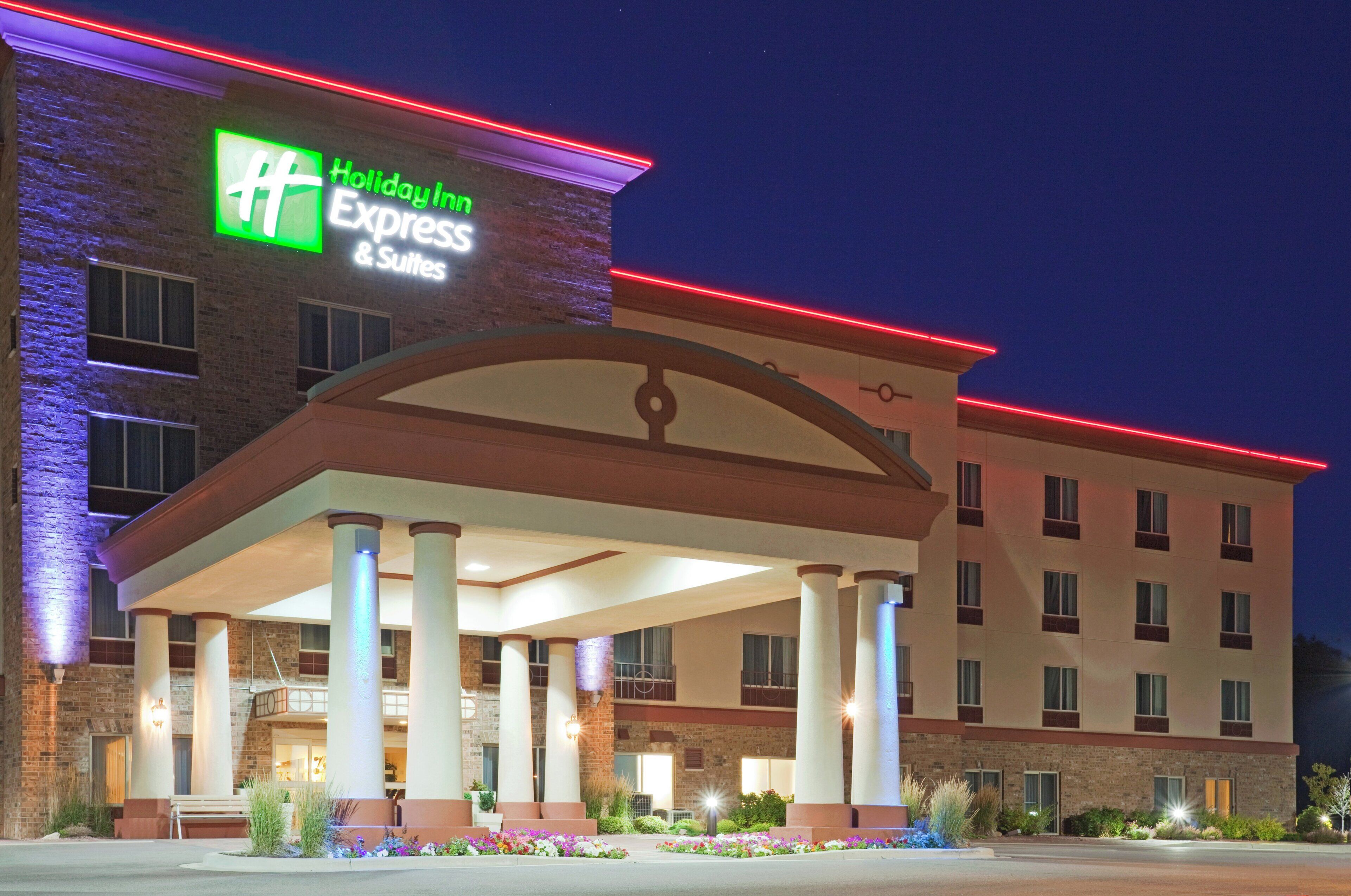A Holiday Inn Express & Suites hotel with a covered entrance and a brick facade.