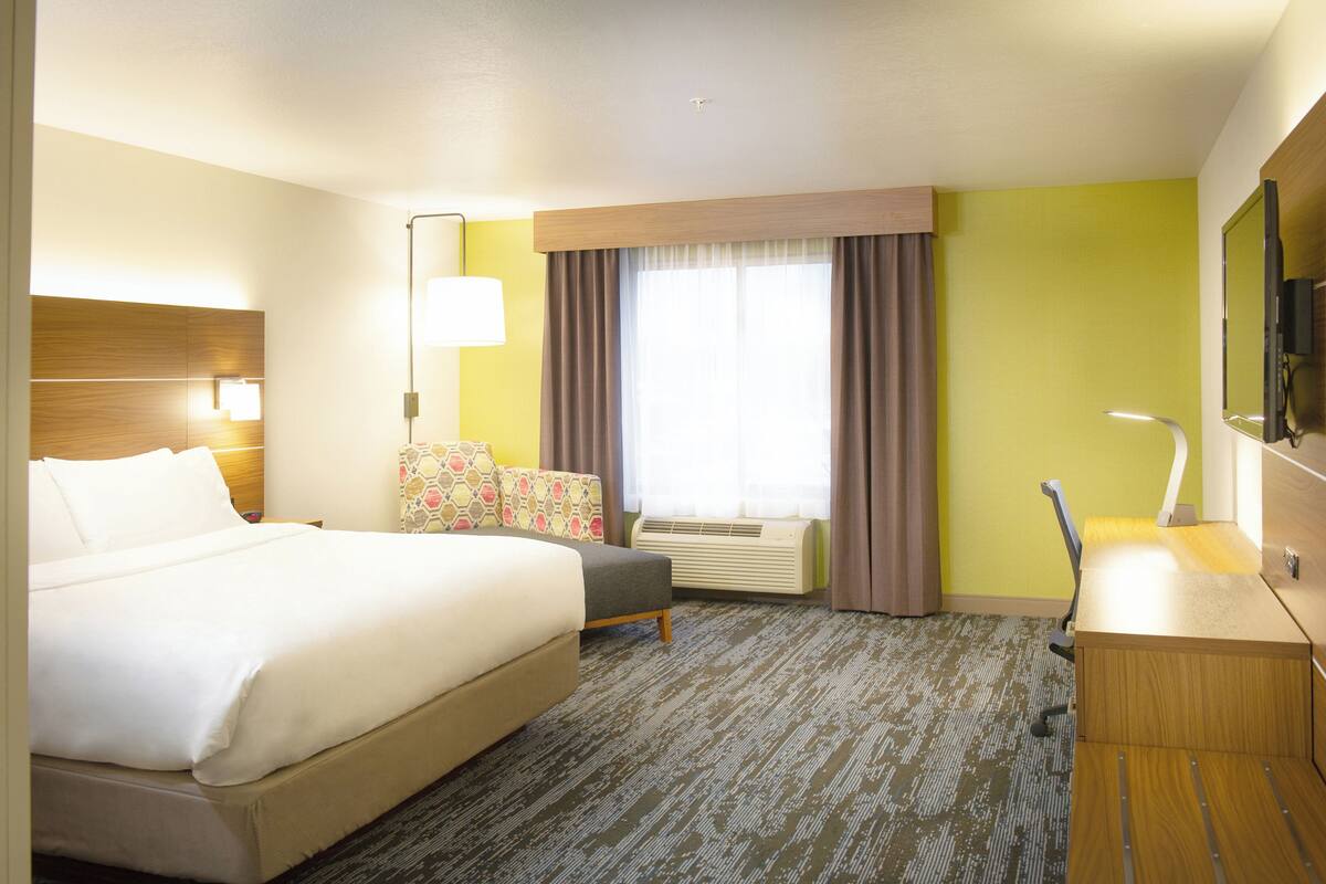 Premium bedding, desk, laptop workspace, blackout drapes