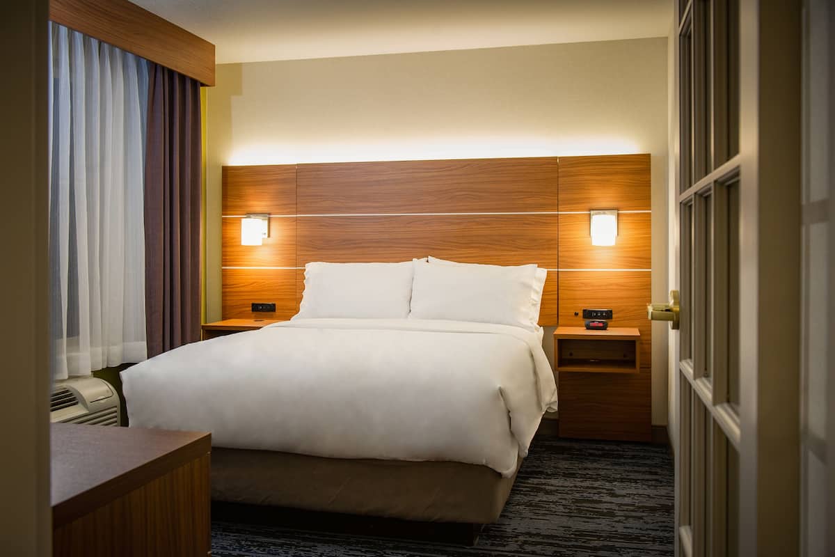 Premium bedding, desk, laptop workspace, blackout drapes