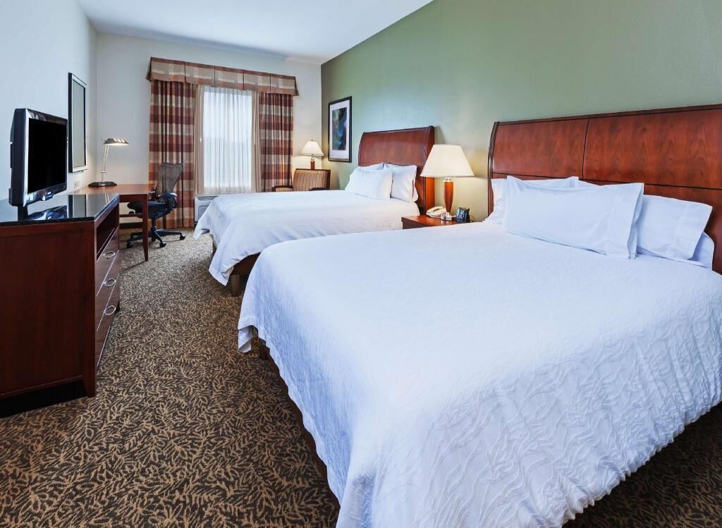 Premium bedding, desk, laptop workspace, blackout drapes