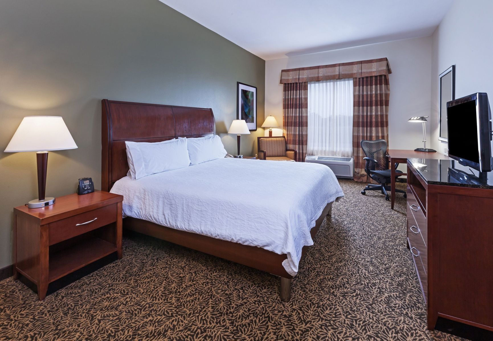 Premium bedding, desk, laptop workspace, blackout drapes