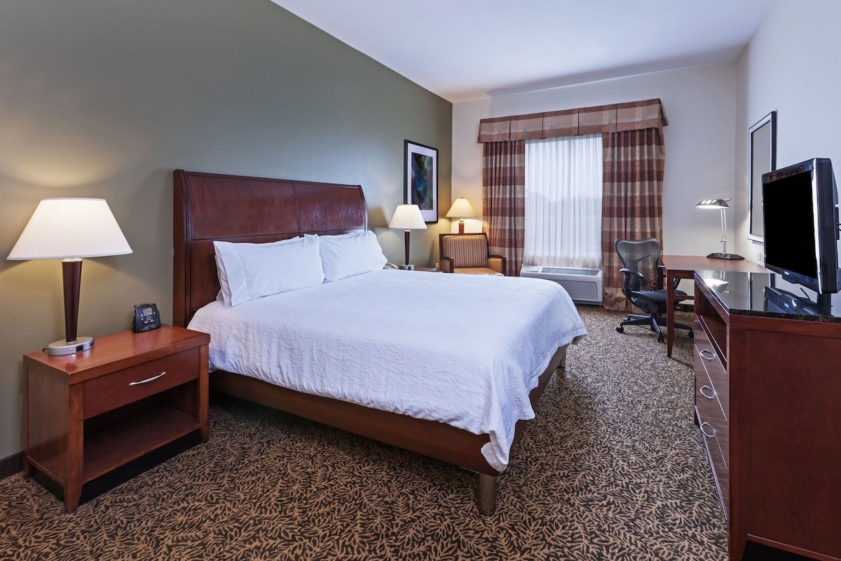 Premium bedding, desk, laptop workspace, blackout drapes