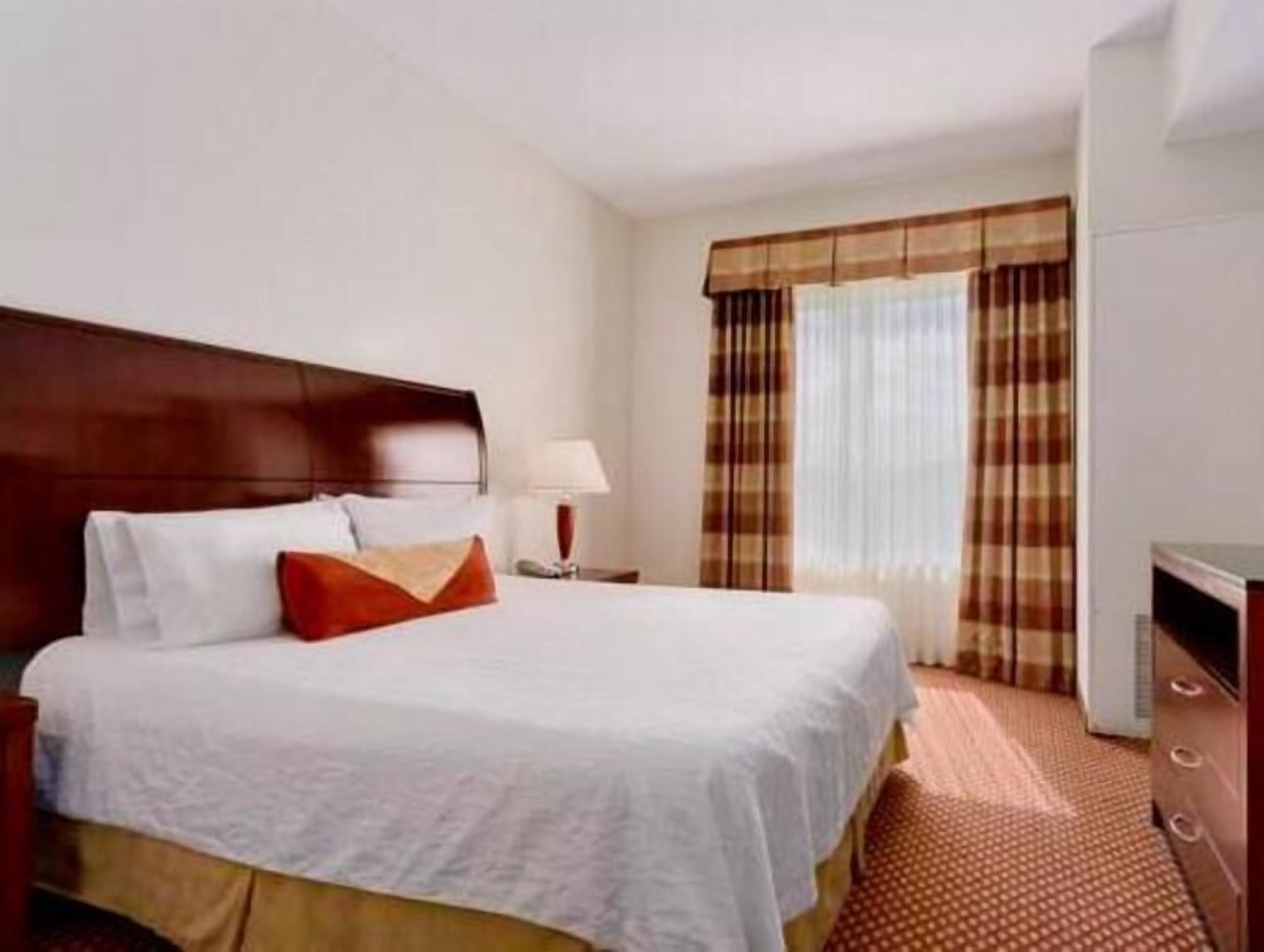 Premium bedding, desk, laptop workspace, blackout drapes