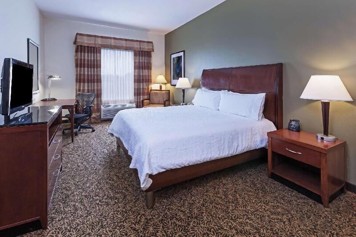 Premium bedding, desk, laptop workspace, blackout drapes