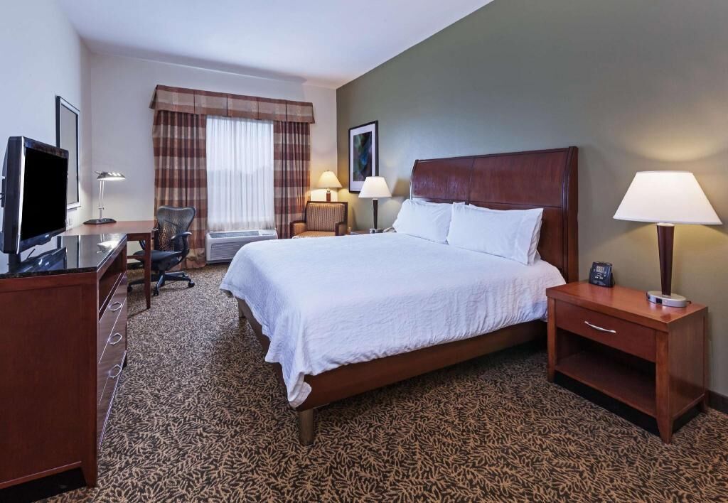 Premium bedding, desk, laptop workspace, blackout drapes