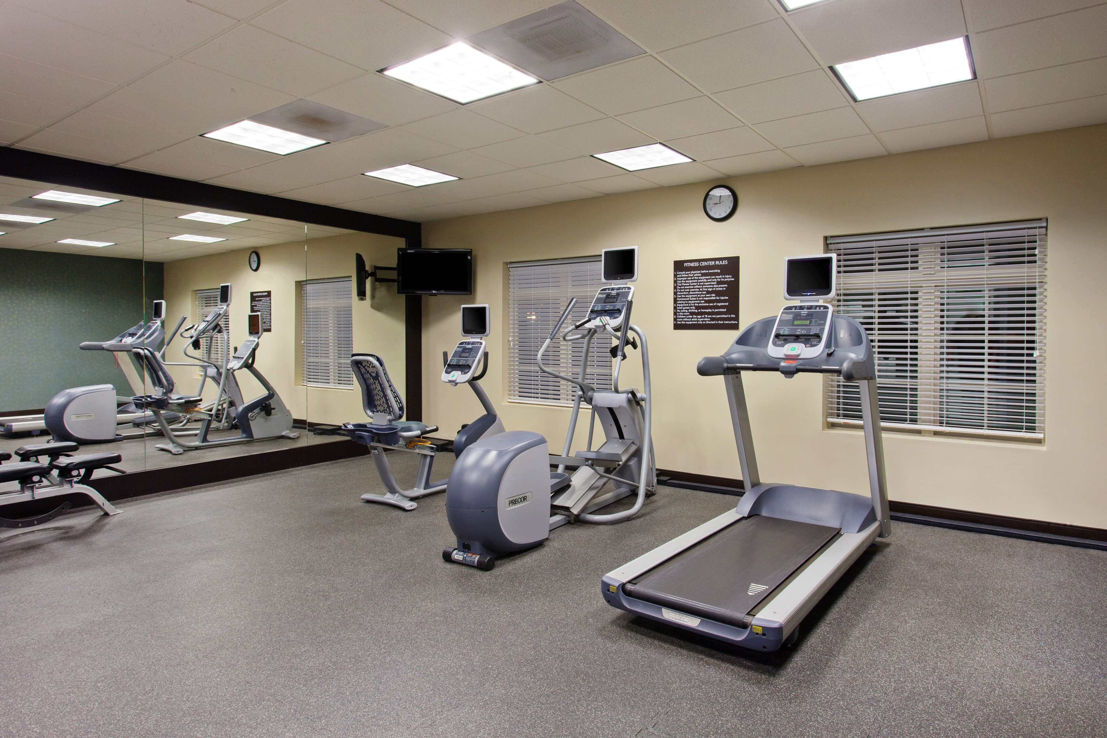 A gym with treadmills, elliptical machines, and stationary bikes.