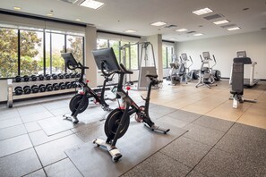 A gym with cardio machines, dumbbells, and a treadmill. - Hilton Dallas/Southlake Town Square (Southlake)