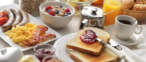 Un desayuno con diversas opciones de comida y bebidas.