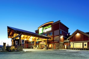A Holiday Inn Express building with a covered entrance, stone facade, and large windows. - Holiday Inn Express Kalispell by IHG (Kalispell)