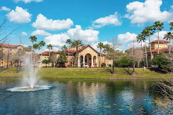 A resort with a pool area, outdoor seating, and a wooden deck. at The Berkley, Orlando