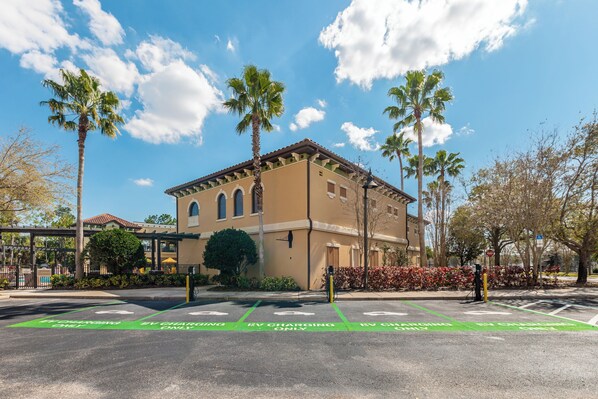 A building with a beige facade, arched windows, and a flat roof. - The Berkley, Orlando (Kissimmee)