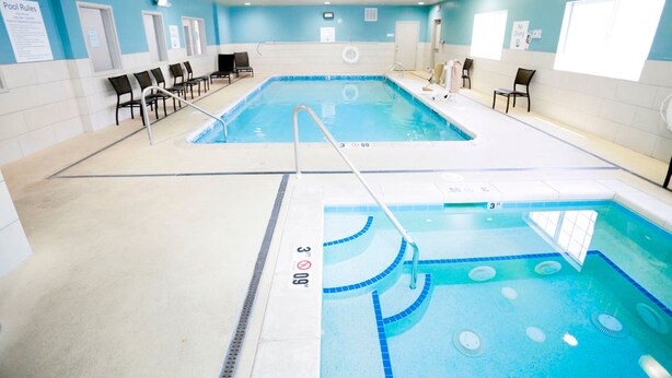 An indoor swimming pool with two lanes, marked depth lines, and a lifeguard chair. - Holiday Inn Express Carlsbad by IHG (Carlsbad)