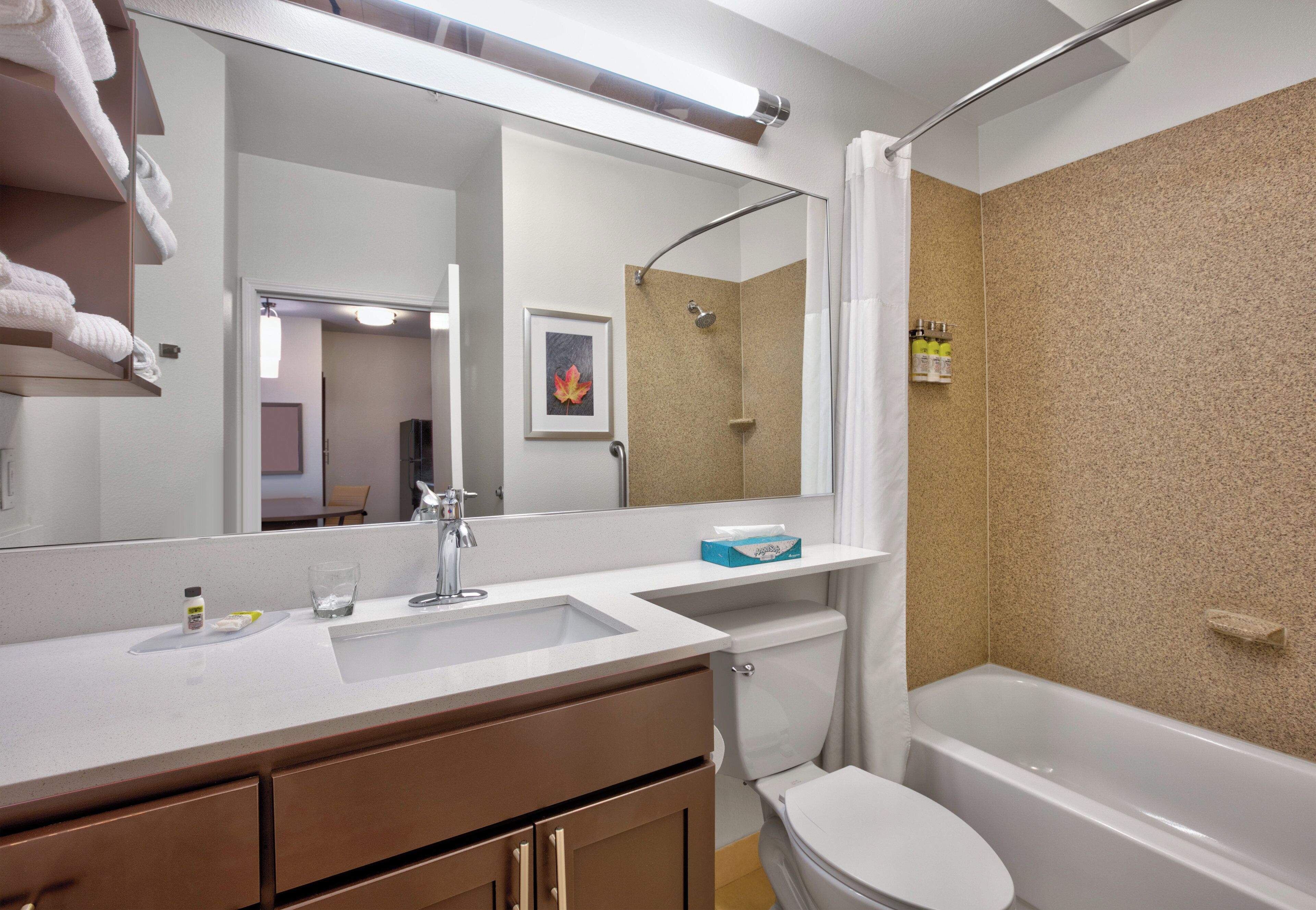A bathroom with a white sink, a toilet, a bathtub, and a shower.
