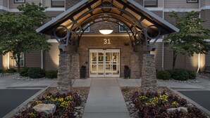 A building entrance with a stone facade, a number '31' above the door, and a modern light fixture above.