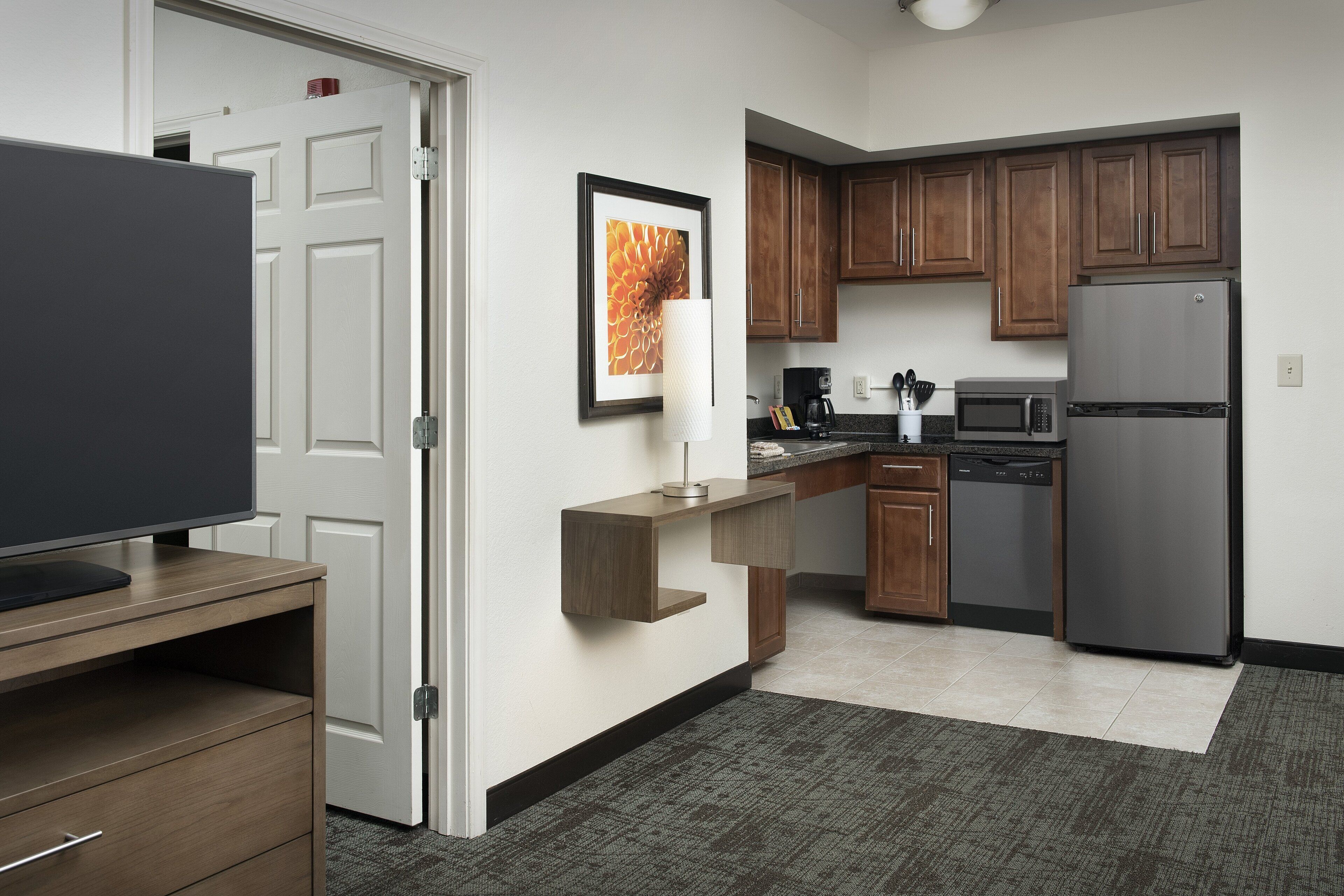 Fridge, microwave, coffee/tea maker, cookware/dishes/utensils