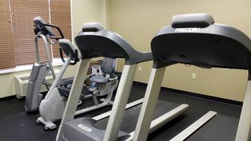 A gym with treadmills and an elliptical machine.