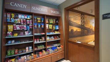 A candy, sundries, and snacks section in a store with various packaged goods on shelves.