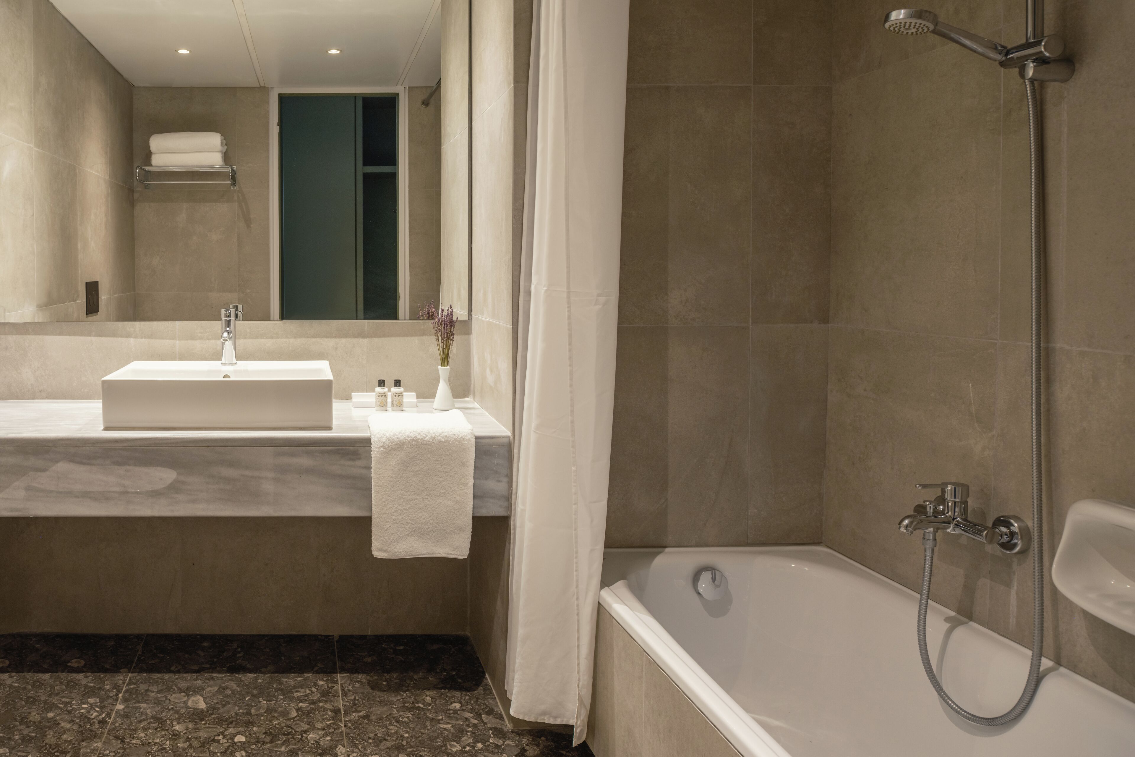junior suite | bathroom | bathtub, eco-friendly toiletries, hair dryer, towels