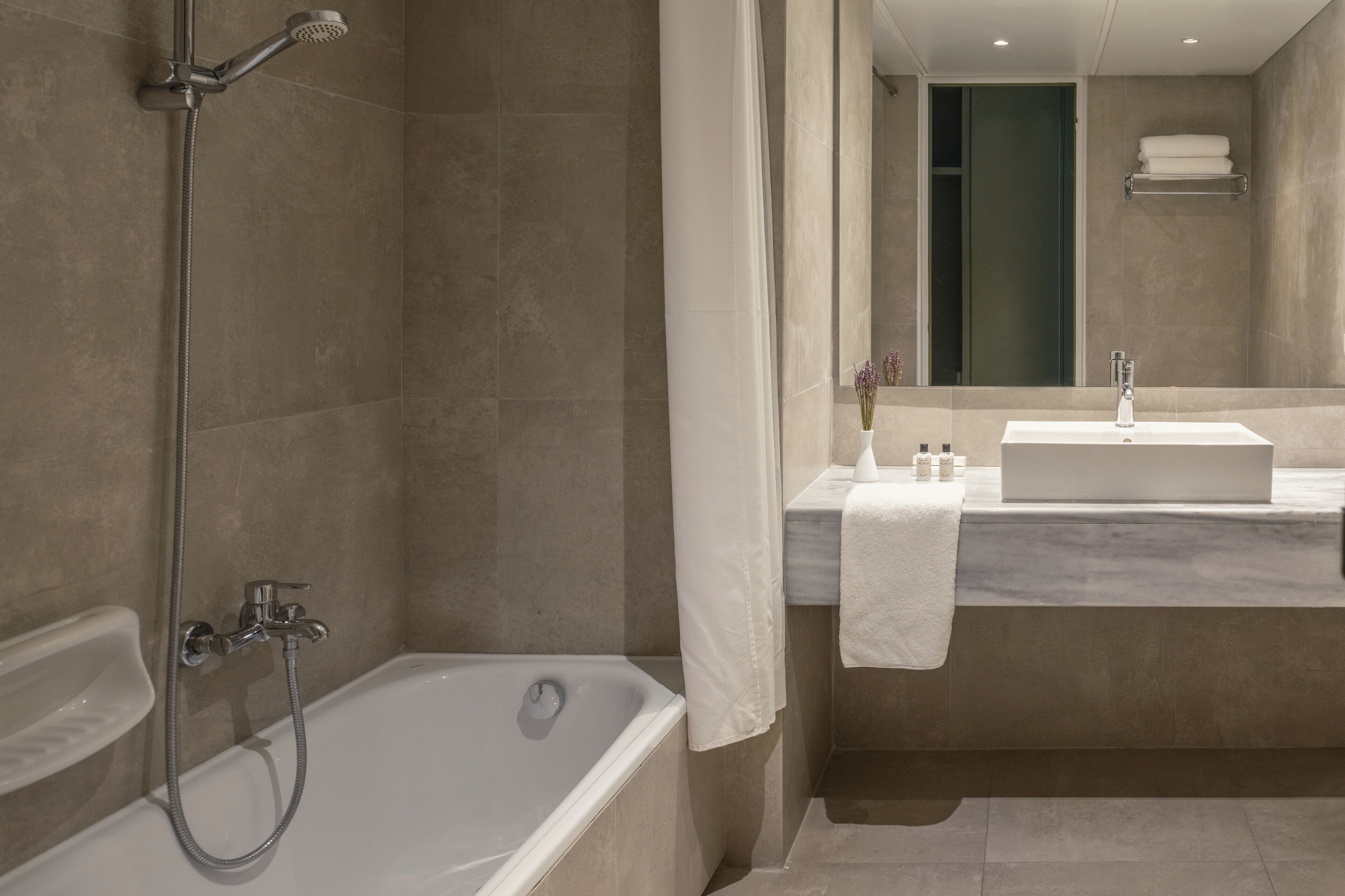 bathtub, eco-friendly toiletries, hair dryer, towels