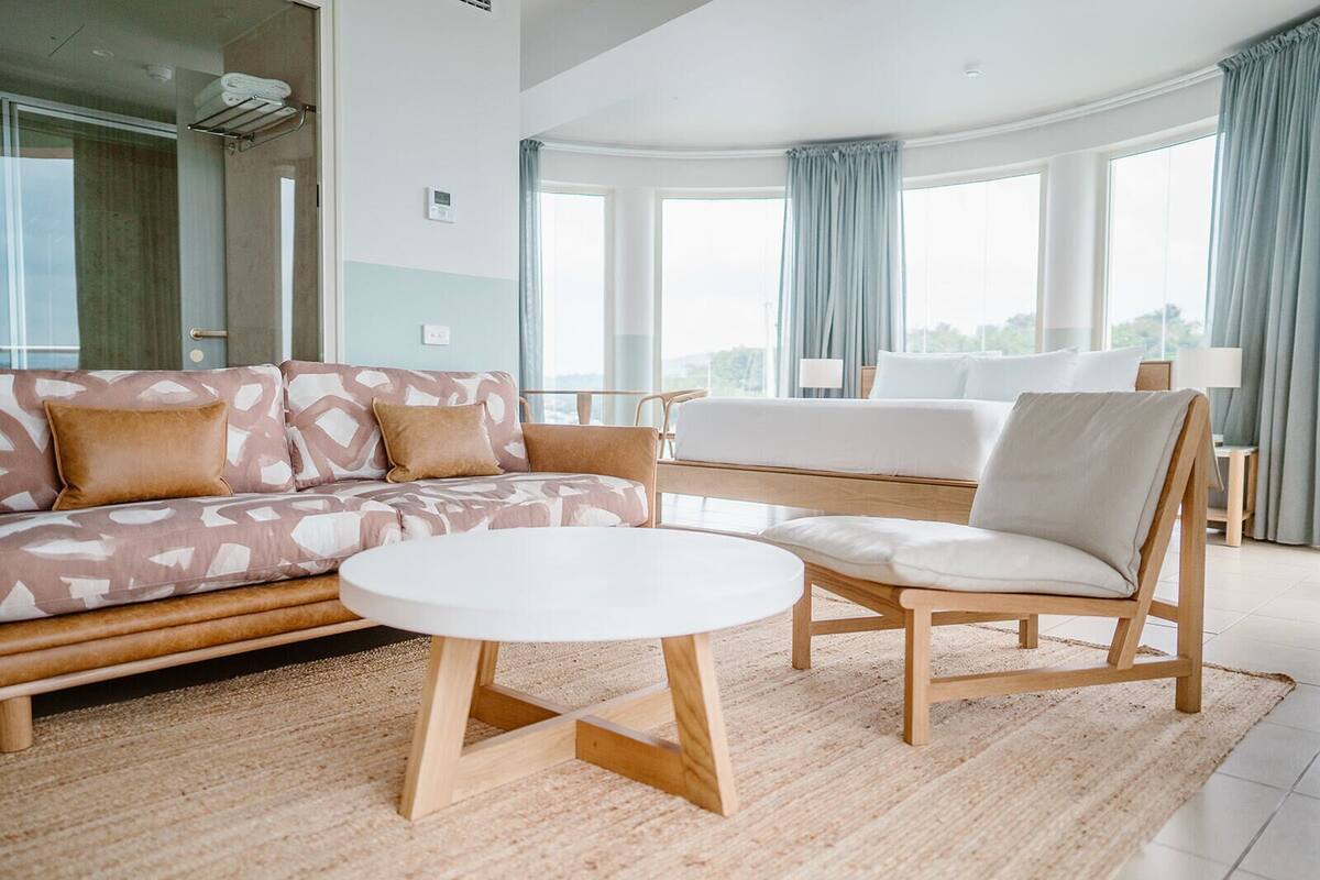 A modern living room with a sofa, a chair, and a coffee table.