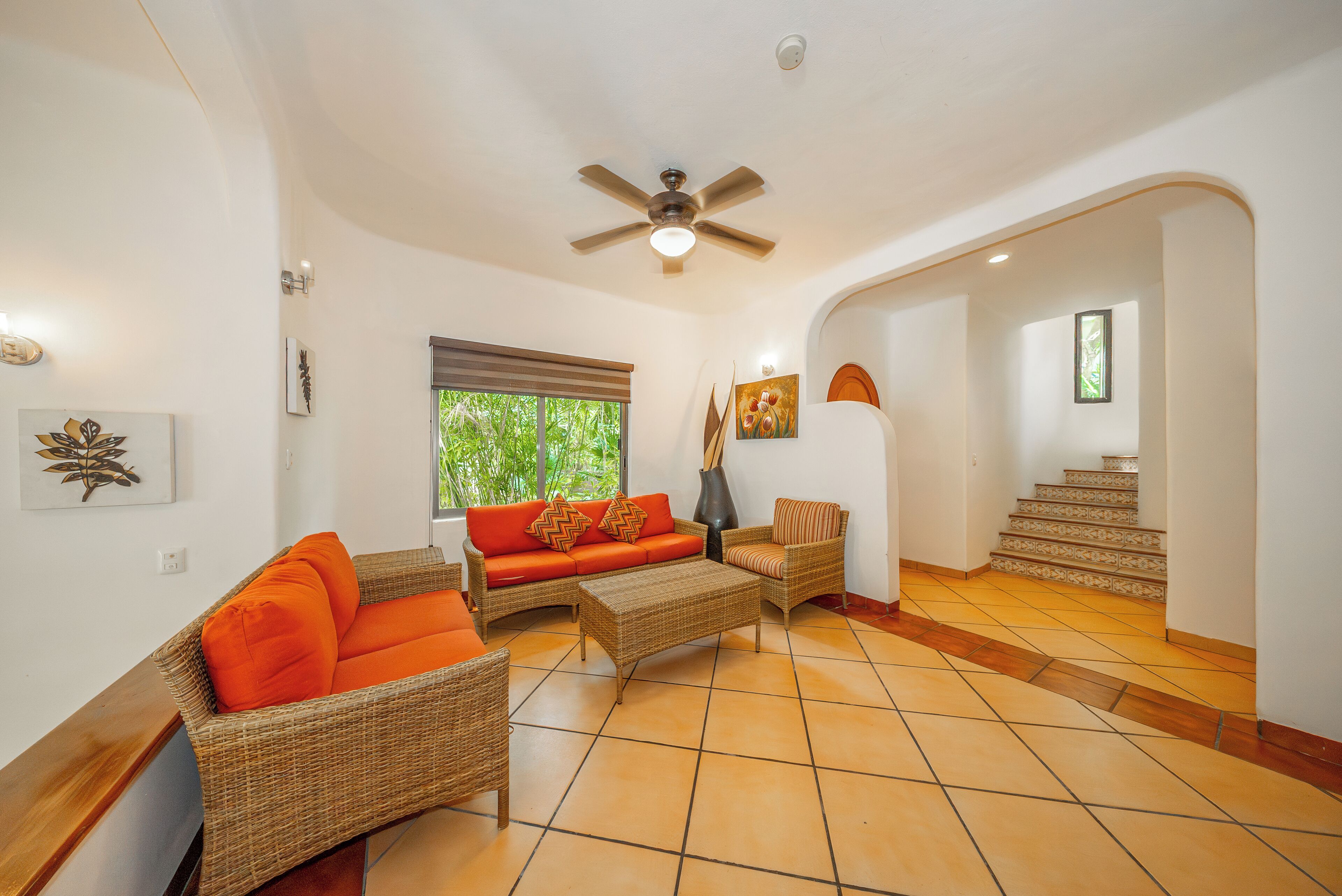 A spacious living area with a sofa, chairs, and a coffee table.