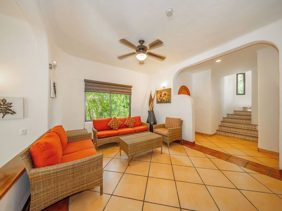 A spacious living area with a sofa, chairs, and a coffee table.