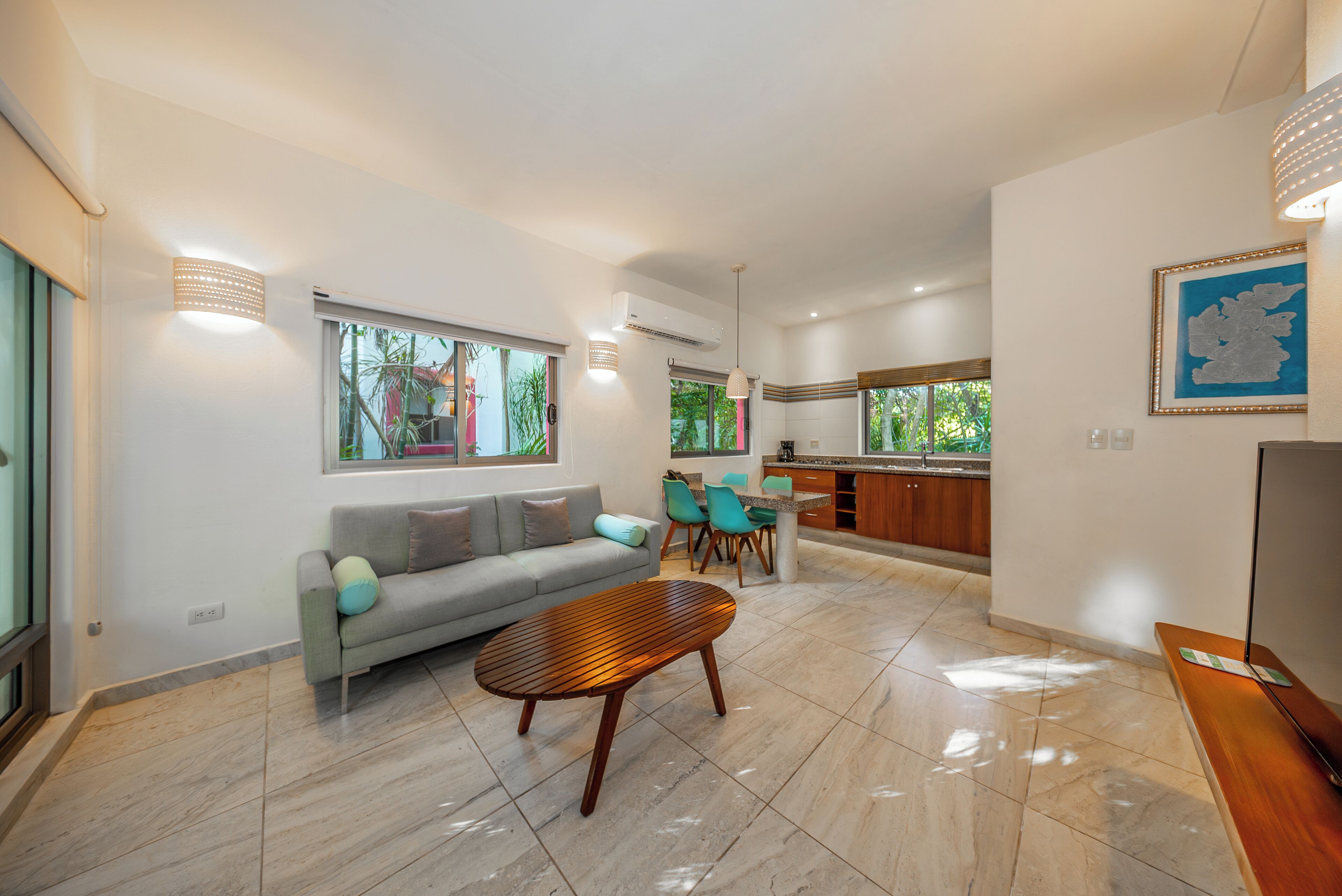 A modern living area with a sofa, coffee table, and dining table.