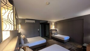 A hotel room with two single beds, a sofa, a desk, and a large window. - All Seasons Hotel (Istanbul)